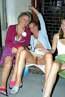 Drunk mature women sit on a step