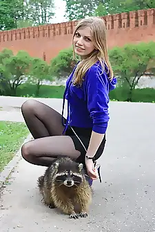 A Russian Handsomeness and her raccoon friend